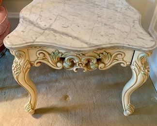 $175 Scalloped-edge marble top table with painted carved wood base. 21.5"H x 26.5"D x 25.75'W
