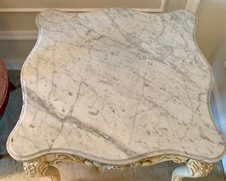 Top view: Scalloped-edge marble top table with painted carved wood base. 21.5"H x 26.5"D x 25.75'W