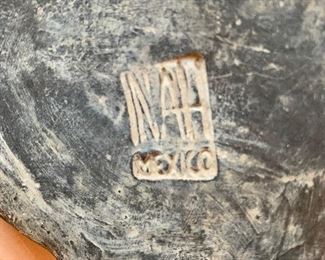 View of mark on bottom of Mexican clay vessel.