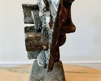Side View: Metal sculpture on square base.  12"H x 4.5"W x 4.5"D