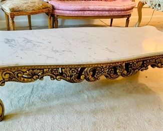 Additional view: Marble top cocktail table with carved gilt base.  16"H x 24.25"D x 59"W 