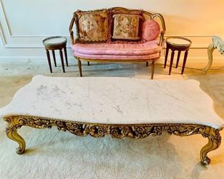 $295 Marble top cocktail table with carved gilt base.  16"H x 24.25"D x 59"W 
