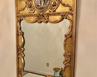 Detail: Gilded mirror with oval tile embellishment