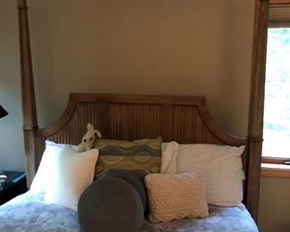 Closer look at headboard for poster bed; various throw pillows.