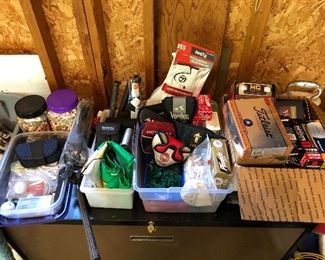 Many new sleeves of golf balls and numerous golf accessories.