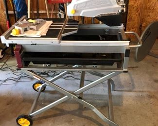 Chicago Electric power saw with rolling stand.