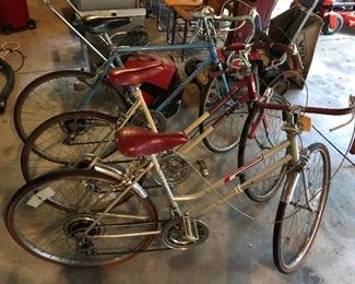 Three vintage bicycles, including a Schwinn Varsity and two Columbias.