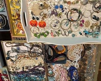 Many trays full of costume jewelry.