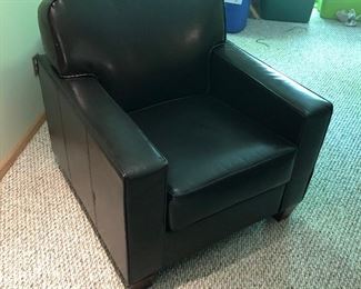 Two nice vinyl/leather-like armchairs. See next photo for the matching chair.