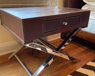 Leather end table on silver cross cross legs.  A little staining on top but it’s cool. 27.5 x 23.5deep x 23 high.  $300