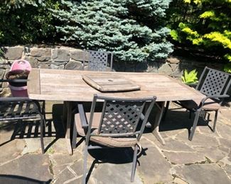 teak table with metal chairs brown