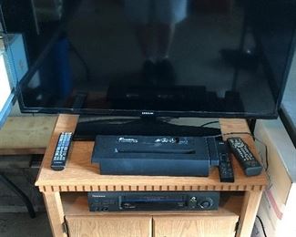 Flat screen TV, DVD player and document shredder All on wooden TV stand