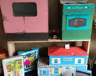 Vintage tin oven, stove, cash register and Barbie carry cases full of dolls and clothes