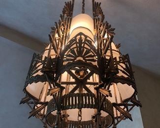Fantastic art Deco bronze chandelier approximately 50” long ( from the top radiating elements to the bottom pendant) & 24” wide. Plastic white curved inserts-not original 