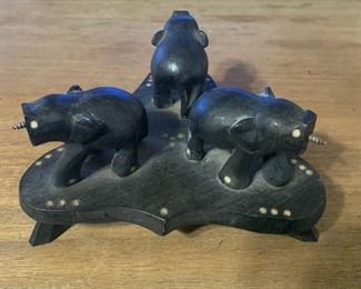 Rare handcarved Folk Art statue of three elephants on a footed pedestal. Ebonized wood and very unqiue. Inlay throughout. Measures 5 1/2" x 3". $35