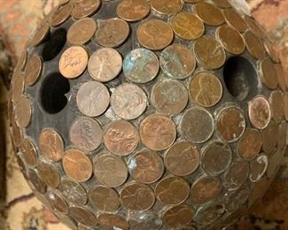 Close up of one of the two bowling balls covered with pennies