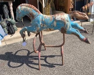 A spectacular antique iron horse on stand. This is original and early. Original paint in blues and reds. It appears the stand was added later although still super old. Would have been part of an old child's ride. Truly one of a kind piece. Originally from a collector. Measures 42" x 37". Heavy - $750