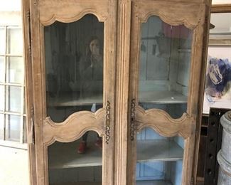 1800's Antique french bleached cabinet.  Glass doors with beautiful french blue painted interior with shelves.  $1,280