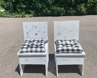 Two white distressed chairs with storage. Great for a mudroom or kids room. The seat opens up to reveal storage inside. Black and white checked cushions come with them. $65 for pair