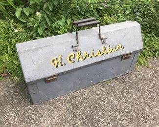 Vintage metal tool box with name "H. Christian" painted across top. All original hardware. Top opens like a book not a lid. Inside is all one open space. All metal. Measures 24" x 11" x 9." $32