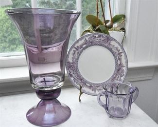 Purple glass vase. Unsigned  $35
14" tall, 8.5" diameter. Hand blown, Bowl is attached with hot glass, not hand blown as a single unit
Purple transferware plate, has a chip $5
Purple glass loving cup  $10
4.25" tall, 5.25" wide at handles. Chips along bottom edge
