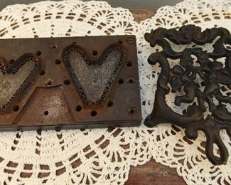 Die cut jig for side by side hearts SOLD
Cast iron figural trivet $4 6.25" x 4.5". The end of the handle has a piece broken off.