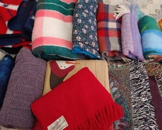 assortment of lap blankets, wool throws.