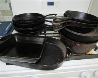 A good selection of well seasoned cast iron cookware