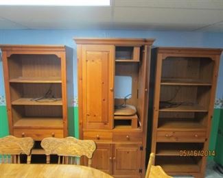 All three units, but not secured to each other. Center unit holds television and DVD or gaming components. Center has three drawers and two cupboards. Doors hide tv when not in use
