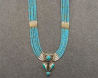 Silver and brass necklace from Tibet with turquoise and coral