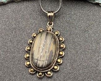 Silver and brass stone pendant with snake chain from Tibet (spots are from the light box)