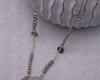 Fine silver statement necklace with geometric, elephant, floral and leaf charms and front closure from Thailand