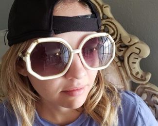 Emily wearing giant 70's sunglasses