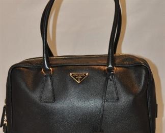 BLACK LEATHER LOCKING DOUBLE HANDLE PRADA TOTE/COSMETIC BAG WITH SATIN INTERIOR IN EXCELLENT CONDITION (WITH DUST COVER), 12"W X 7.5"H X 3.5"D. OUR PRICE $225.00