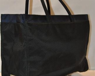 TWO TONE NAVY INTERIOR AND BLACK NYLON EXTERIOR PRADA TOTE WITH FOUR EXTERIOR POCKETS IN EXCELLENT CONDITION, 13.75"W X 9.5"H X 4"D. OUR PRICE $150.00  