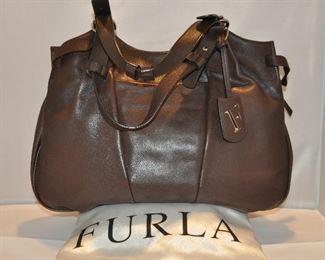 BROWN LEATHER FURLA TOTE WITH DOUBLE HANDLES AND TIE SIDE POCKETS IN EXCELLENT CONDITION, (WITH DUST COVER). 16.5"W X 13"H. OUR PRICE $175.00