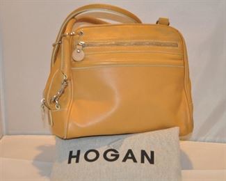 CARMEL LEATHER DOUBLE HANDLE HOGAN HANDBAG WITH SILVER HARDWARE AND ONE ZIPPER FRONT POCKET IN EXCELLENT CONDITION, (WITH DUST BAG). 10.5"W X 9.5"H X 6.5"D. OUR PRICE $145.00