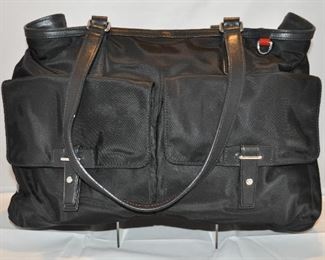BLACK NYLON WITH LEATHER TRIM TUMI CARRY ON TOTE/HANDBAG LIKE NEW (WITH DUST COVER). 17”W X 12.5” H X 5” D.  OUR PRICE $260.00