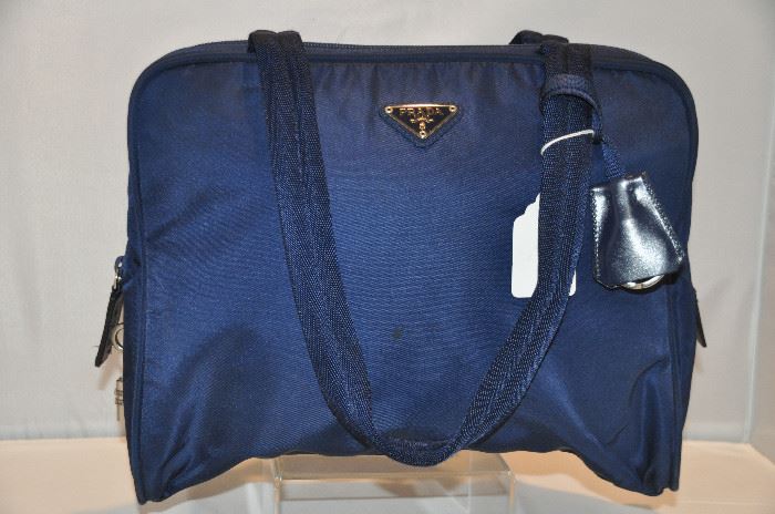 NAVY LARGE NYLON PRADA COSMETIC BAG WITH LOCK AND KEY, IN EXCELLENT CONDITION (INCLUDES DUST BAG), 12" X 9". OUR PRICE $295.00