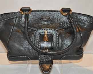 BLACK PEBBLED LEATHER TOD’S BUCKLE FRONT HANDBAG WITH GOLD HARDWARE AND TWO INTERIOR POCKETS IN EXCELLENT CONDITION (WITH DUST COVER), 8.5"H X 13.5"W X 5.25"D. OUR PRICE $175.00 