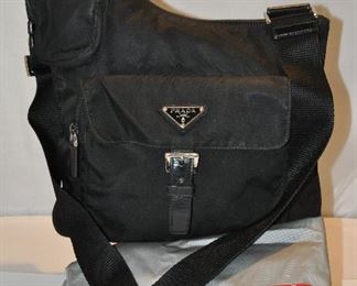 AUTHENTIC BLACK NYLON PRADA CROSSBODY WITH FRONT POCKET AND SILVER TRIM (WITH DUST BAG), 11.5"W X 10"H. OUR PRICE $275.00