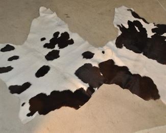 A PAIR OF AUTHENTIC SMALL BROWN AND CREAM SKINS, APPROX. 35"LONG X 42"W. OUR PRICE $75.00 PAIR