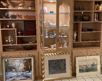 Lovely three sectioned display center, bookshelf, storage. There are large cabinets with shelves on the bottom. Center piece is lighted with glass shelves and doors, end pieces are open shelving.  Price $595