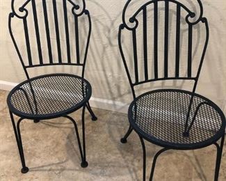 Pair of vintage iron  outdoor chairs, comes with tan & white stripe cushions