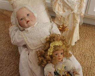 #20.  40.00. Lot 3 porcelain dolls baby in lounger