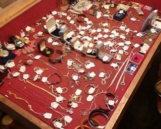 Display case of gold, silver and smalls as displayed prior to the sale.