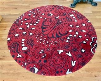 $120  Circular red modernist rug.  5' diam. 