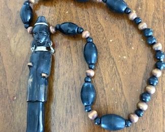 $20 Tribal man on beaded necklace (black/gray).  20" L. 