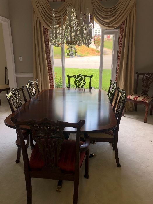 Mahogany Henkel Harris table with 3 leafs and custom table pads. 12 Maitland Smith Chairs. 