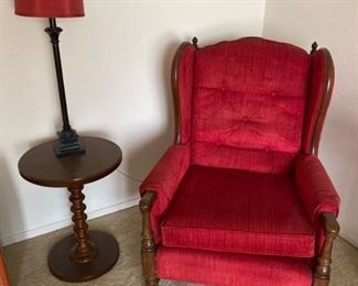Two matching red chairs with table and lamp